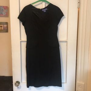 Sweetheart-neck, black dress. Knee length.